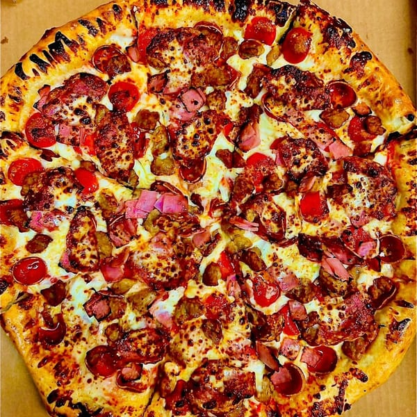 A Doughboys Pizzeria pizza, loaded with pepperoni, sausage, ham, and melted cheese.